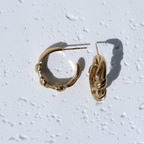 Chunky Vintage Gold Twisted Hoops on plaster background
