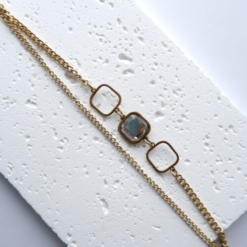 The Deco Square Double-Chain Bracelet on plaster background