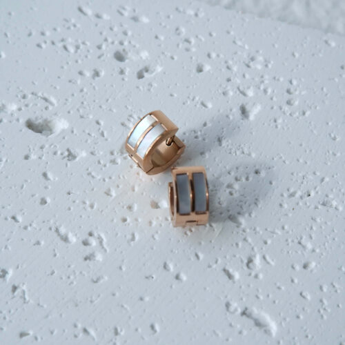 Chunky Double Track Huggie Earrings on plaster background