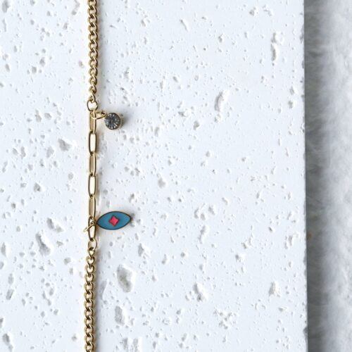 Turquoise Evil Eye Mixed Chain Bracelet on a plaster background