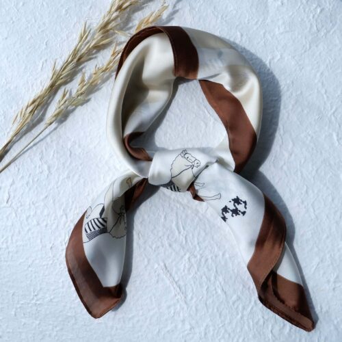 Brown Border Horse Motif Silk Bandana on plaster background