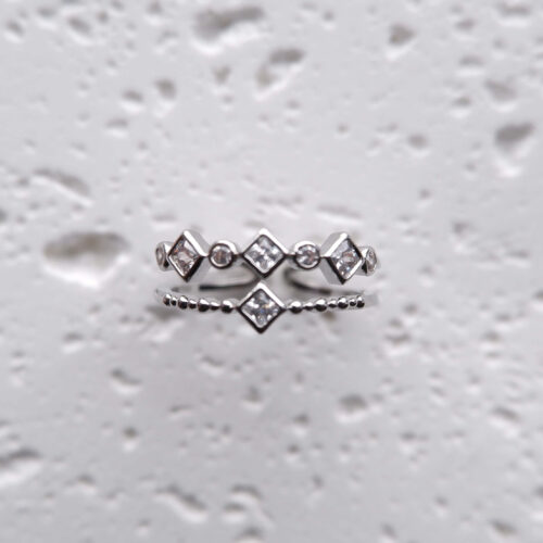 Silver Double Layer Geometric Crystal Ring on a plaster background