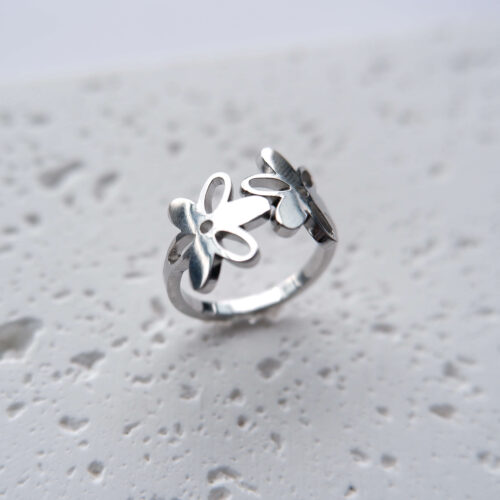 Silver Cut-out Double Flower Ring on plaster background