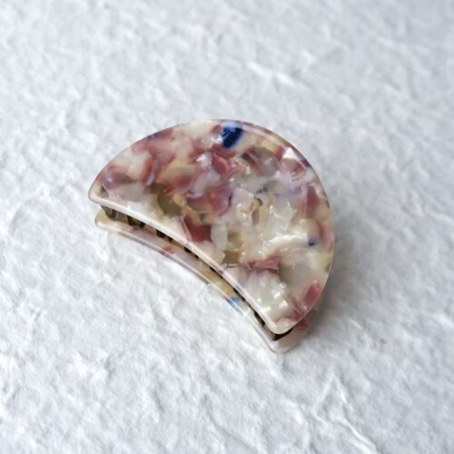 Marbled Acetate Crescent Hair Claw on a plaster background