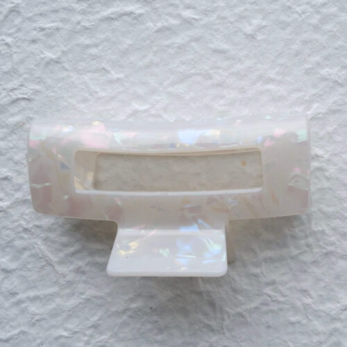 Iridescent Pearl Rectangular Open Frame Claw Clip on plaster background