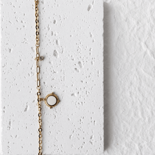 Mixed Paperclip Chain Compass Bracelet on a plaster background