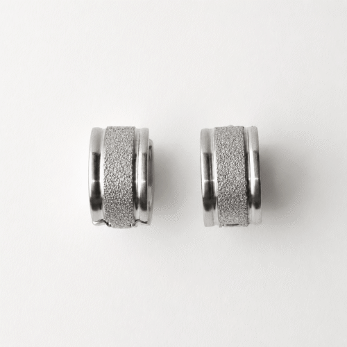 Wide Silver Hoop Earrings with Textured Glitter on white background
