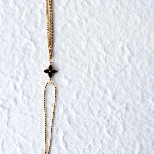 Half Beaded Half Curb Black Floral Bracelet on plaster background