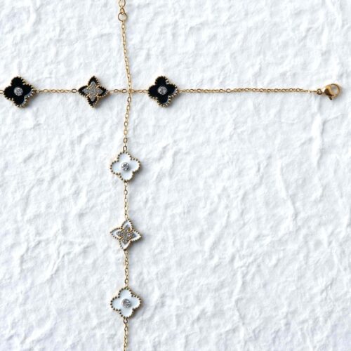 Gold Beaded Clover Gemstone Bracelet on plaster background